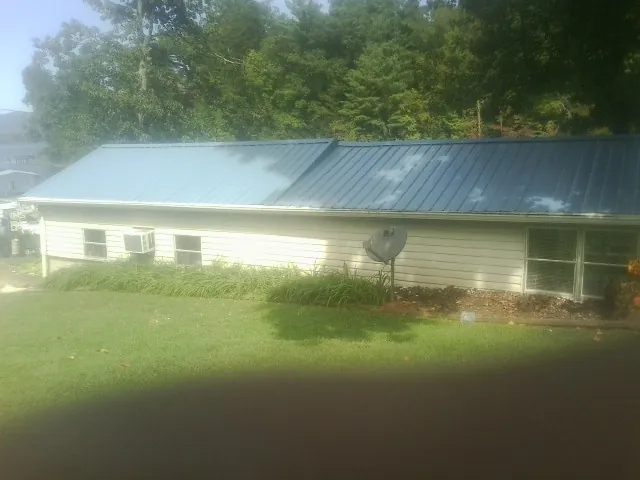 Blue metal roof running the length of a single story home in Delevan